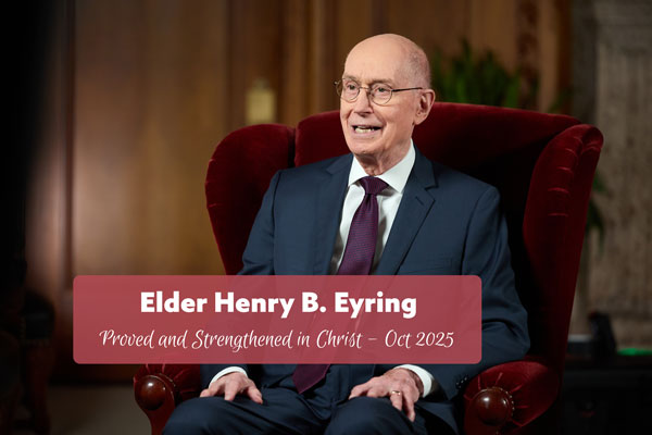 elderly gentleman wearing a suit and sitting in a red chair